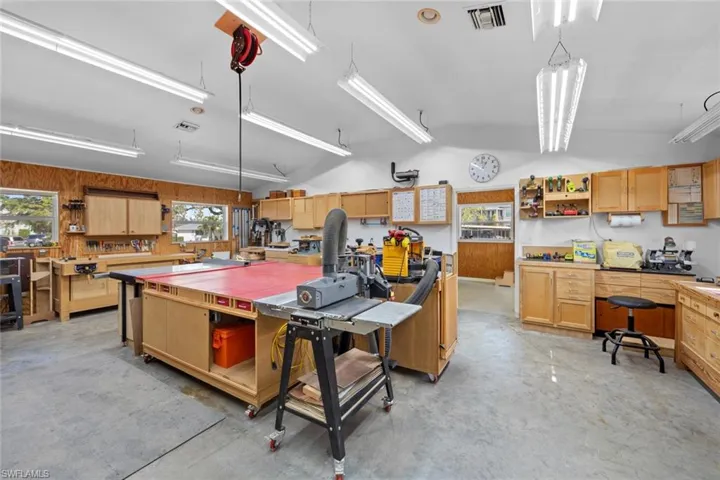 Kitchen with a center island, hanging light fixtures, and wooden walls
