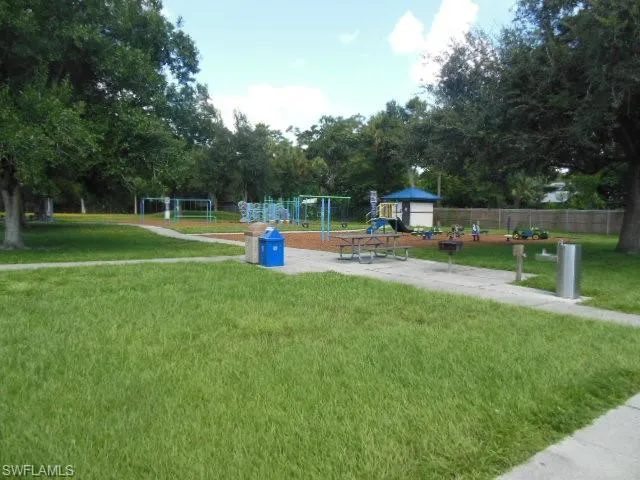 View of community featuring a playground and a yard