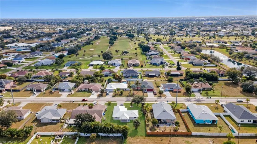 Aerial perspective of suburban area with a large body of water