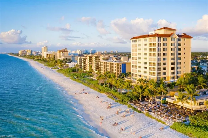 View of urban area featuring waterfront with a beach