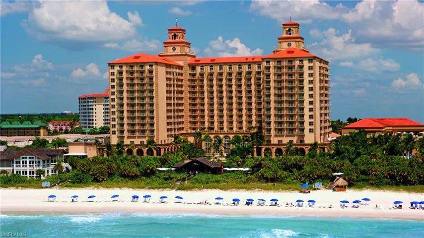 View of building exterior featuring view of water and beach