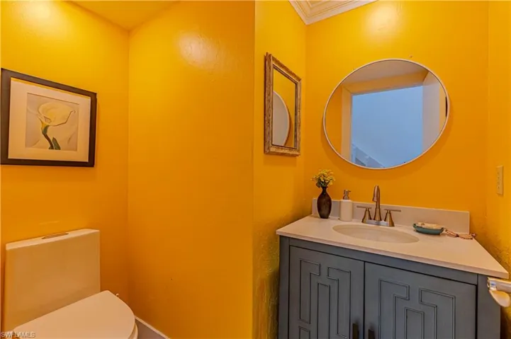 Bathroom with vanity and crown molding