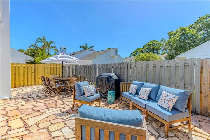 Fenced backyard featuring a patio area, area for grilling, outdoor dining area, and an outdoor living space