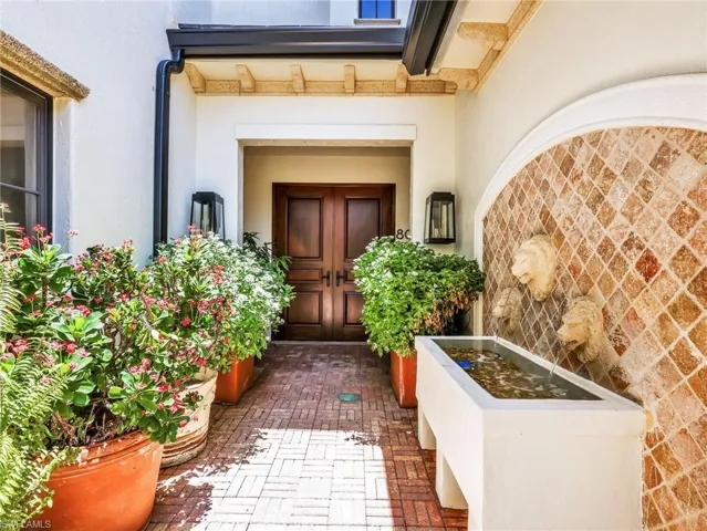 Private entry w/ water feature and lush landscape