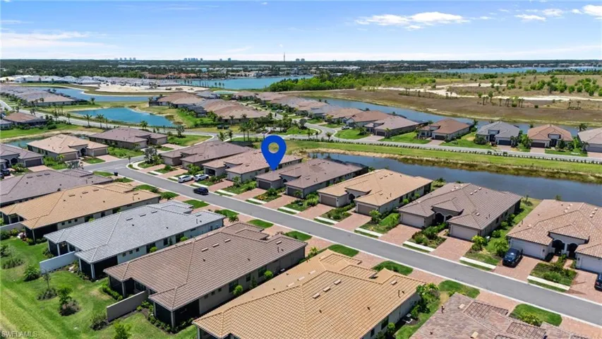 Aerial view of residential area featuring a nearby body of water