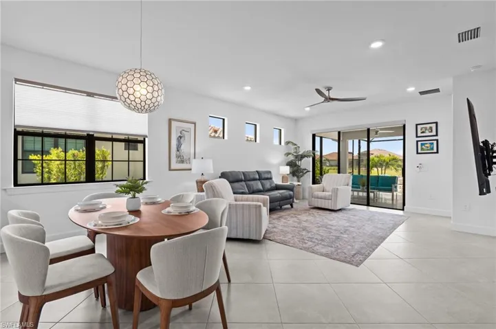 Dining space featuring a ceiling fan, baseboards, recessed lighting, and light tile patterned floors