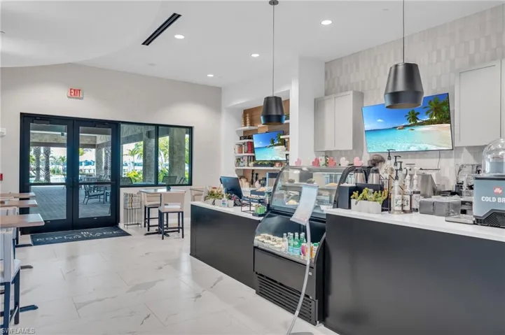 Kitchen featuring french doors, white cabinetry, decorative backsplash, light marble finish flooring, and pendant lighting