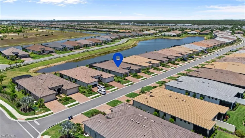 Aerial perspective of suburban area with a nearby body of water
