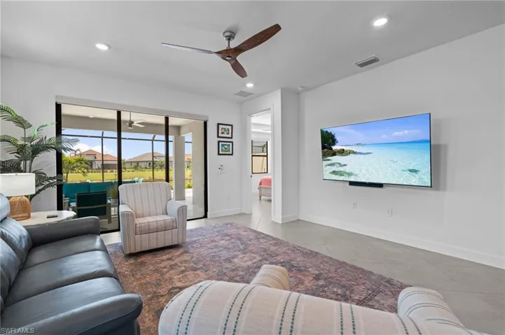 Tiled living area with a ceiling fan, baseboards, and recessed lighting