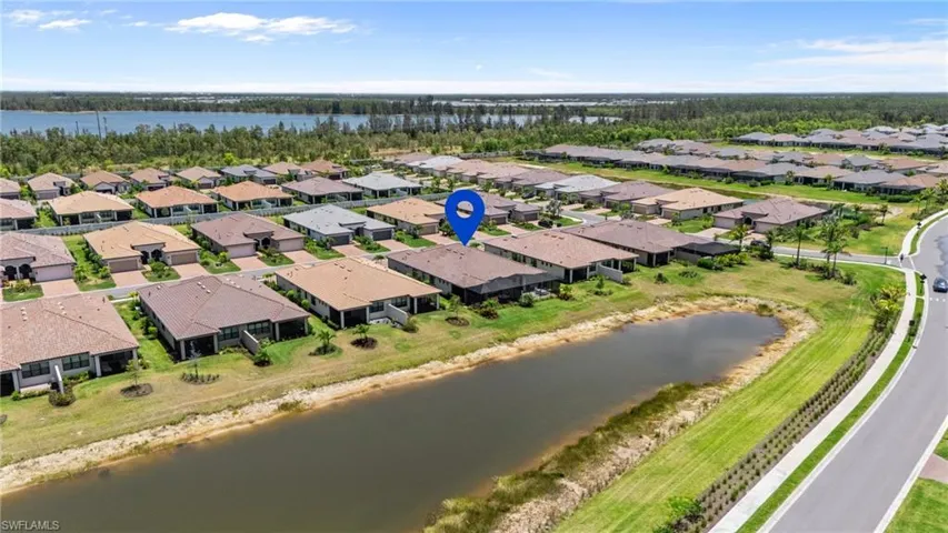 Aerial perspective of suburban area featuring a nearby body of water