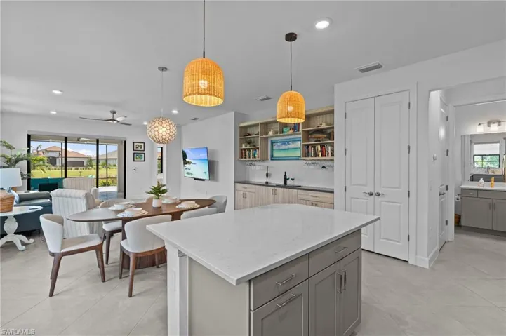 Kitchen featuring gray cabinetry, recessed lighting, healthy amount of natural light, decorative backsplash, and open shelves