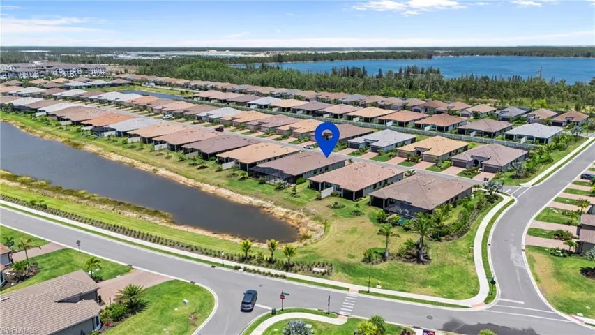 Aerial view of residential area featuring a nearby body of water