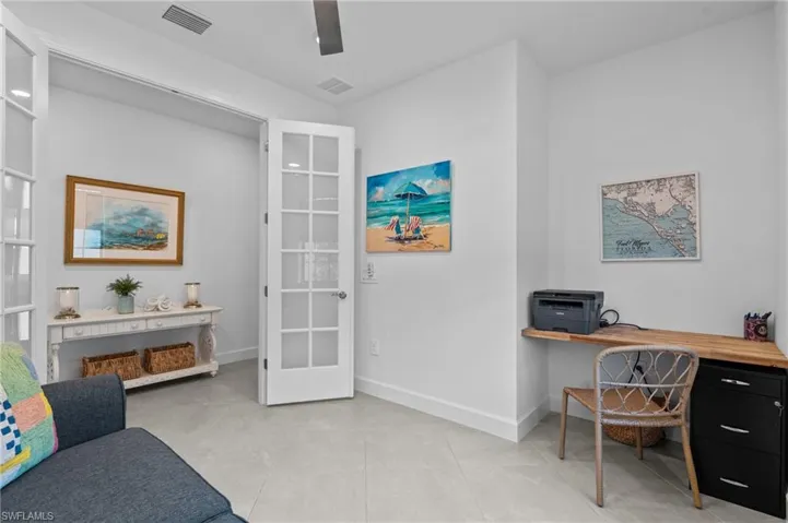 Home office with baseboards and light tile patterned flooring