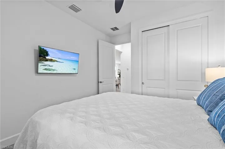Bedroom with a closet, ceiling fan, and baseboards