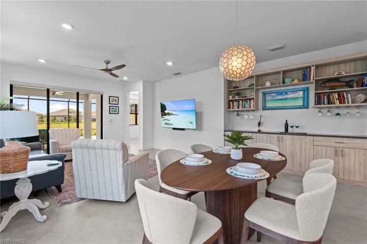 Dining area featuring light tile patterned floors, recessed lighting, and ceiling fan