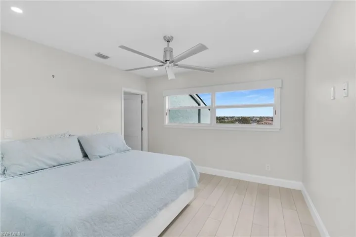 Bedroom featuring wood finish floors, a ceiling fan, and recessed lighting