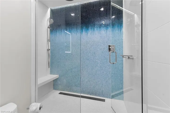 Bathroom featuring a stall shower and toilet