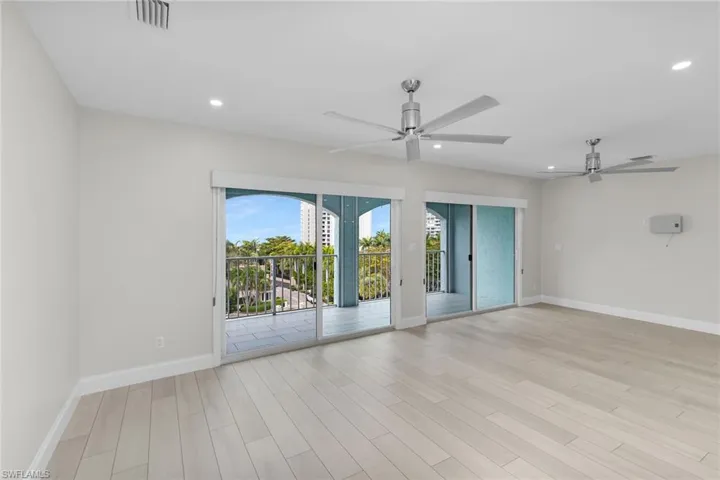 Spare room with light wood-style floors, ceiling fan, and recessed lighting