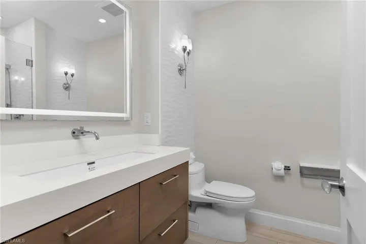 Bathroom featuring vanity and an enclosed shower