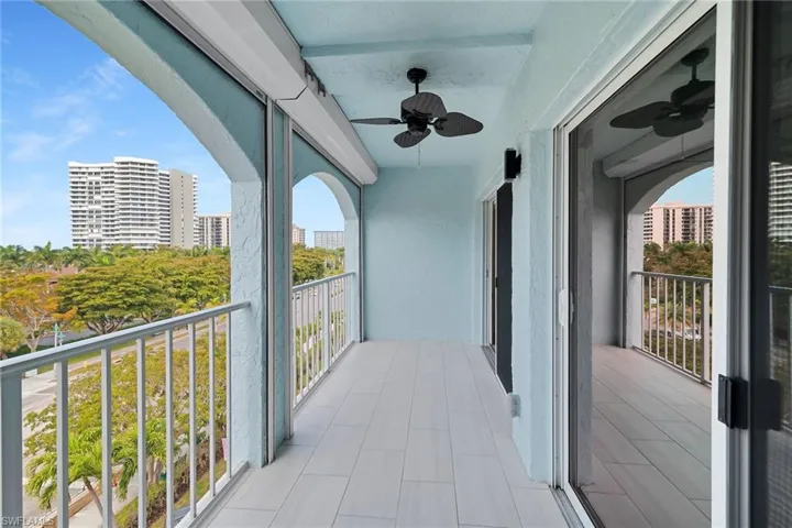 Balcony with ceiling fan and a city view