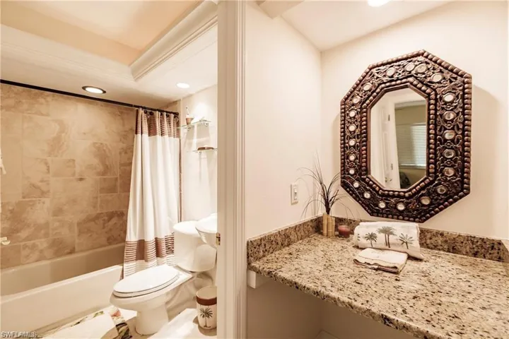 Full bath with recessed lighting, shower / bath combo with shower curtain, and vanity