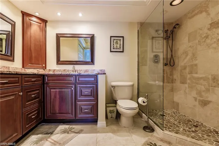 Bathroom with vanity, a walk in shower, recessed lighting, and light tile patterned flooring