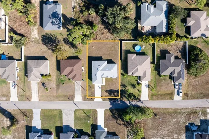 Aerial view of residential area with property boundaries highlighted