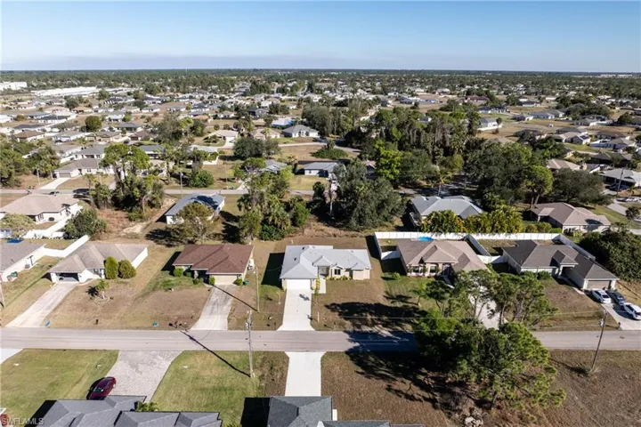 Aerial view of property's location featuring nearby suburban area