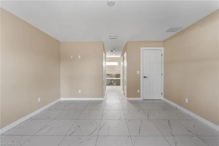 Empty room with light marble finish flooring and baseboards