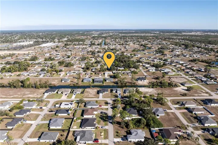 Aerial view of property's location with nearby suburban area