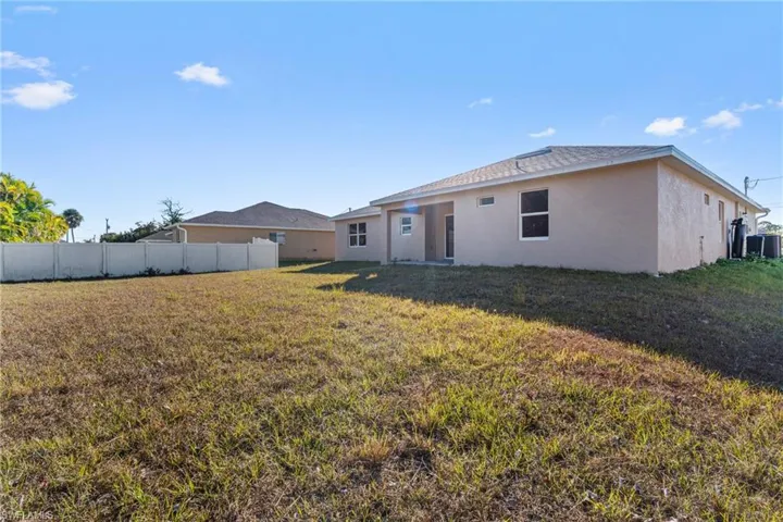 Back of house featuring stucco siding