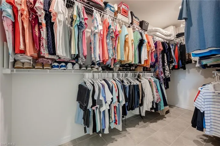 Walk in closet with tile floors