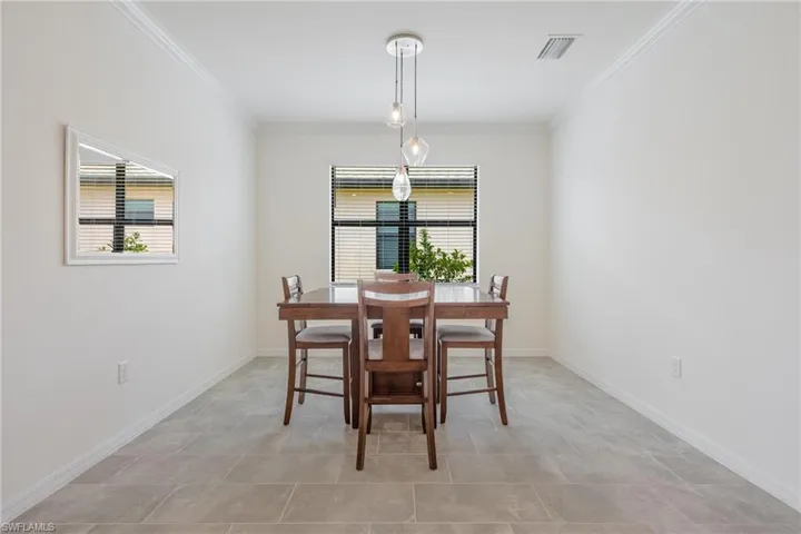 Tiled dining room with crown molding