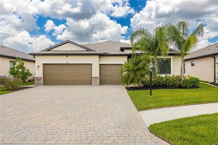 View of front of property with a garage and a front yard