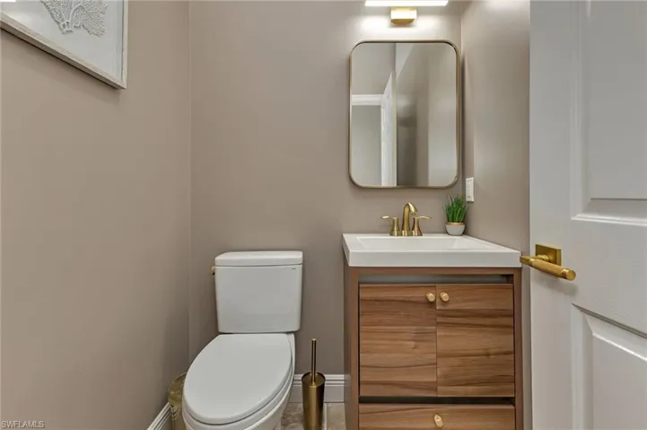 Bathroom featuring vanity, toilet, and tile patterned floors