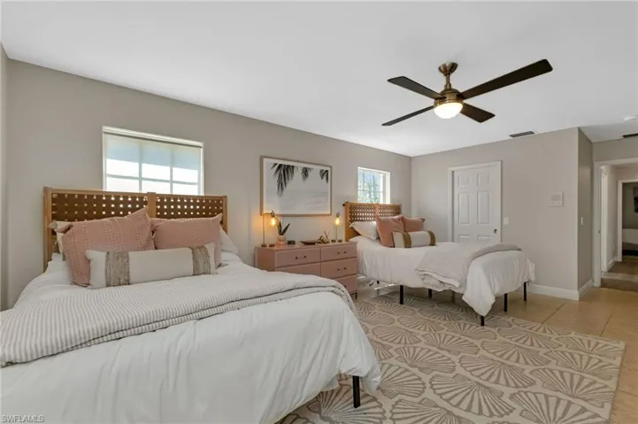 Tiled bedroom with ceiling fan