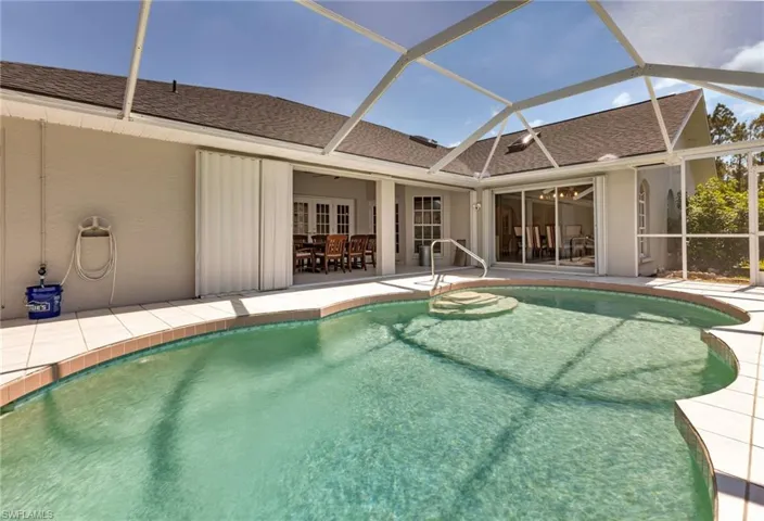 View of swimming pool with a patio and french doors