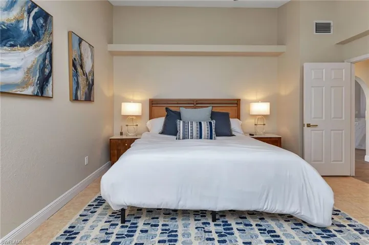 Bedroom with tile patterned flooring and a high ceiling