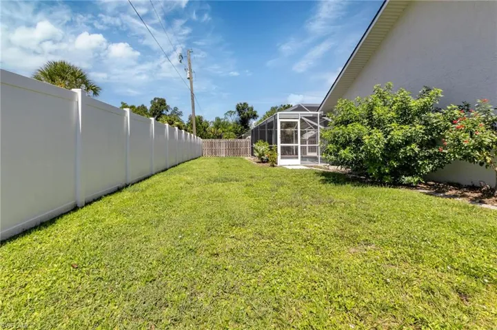View of yard with glass enclosure