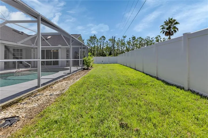 View of yard with a lanai and a fenced in pool