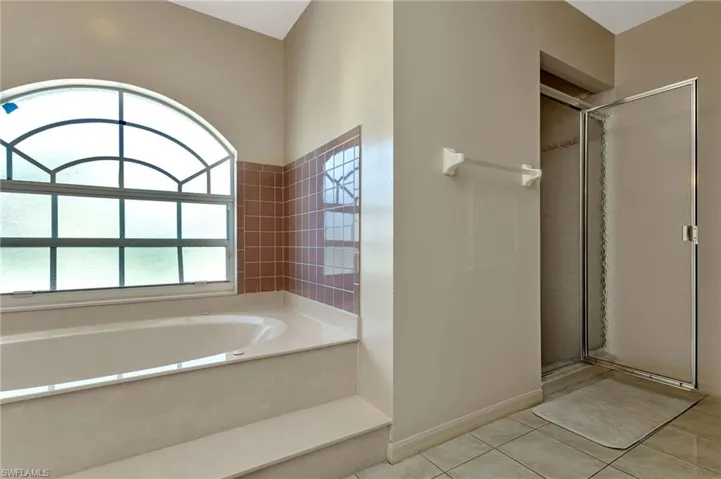 Bathroom with tile patterned flooring and separate shower and tub