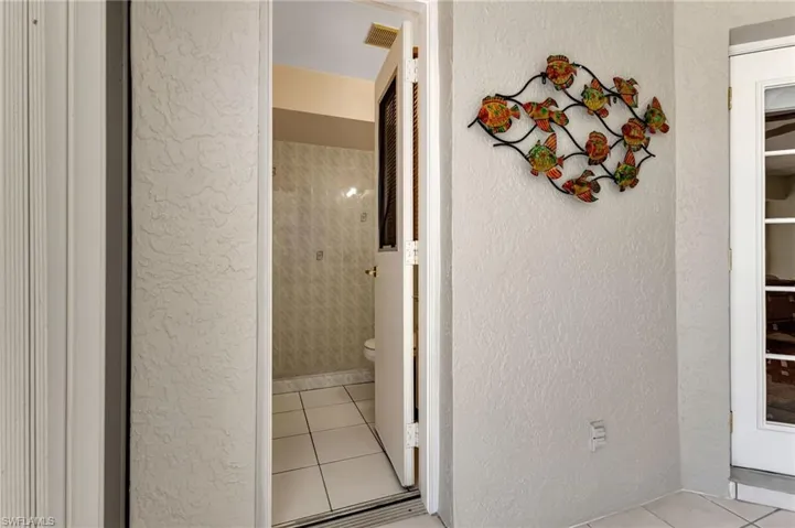 Hallway with light tile patterned floors