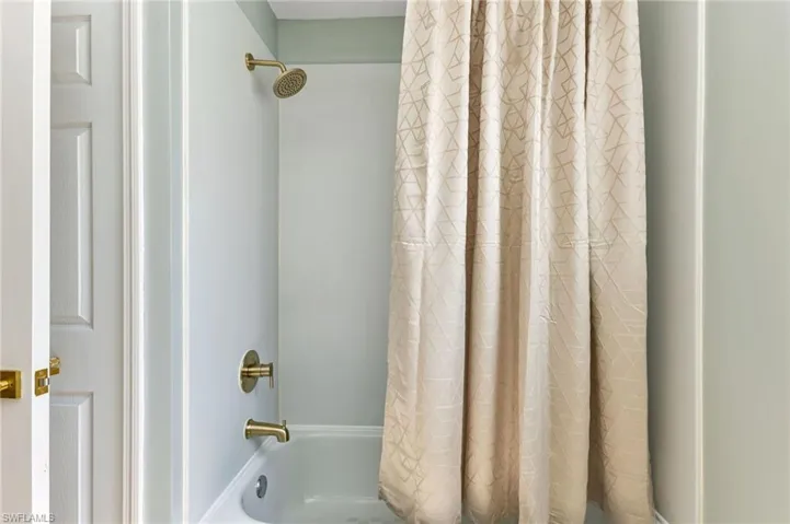 Bathroom featuring shower / bath combo with shower curtain