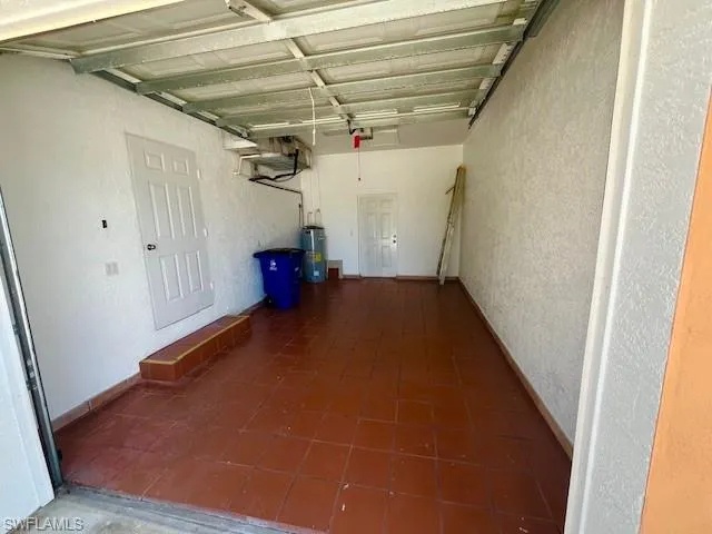 Garage with a textured wall and water heater