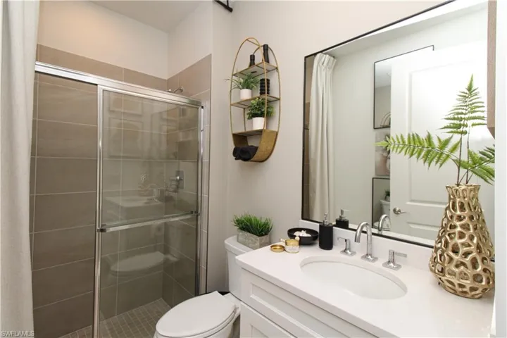Bathroom with vanity and a stall shower
