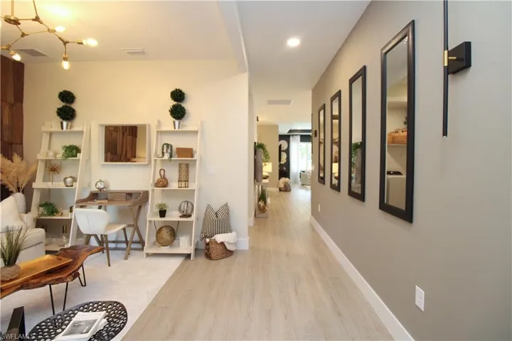 Hall featuring light wood finished floors and recessed lighting
