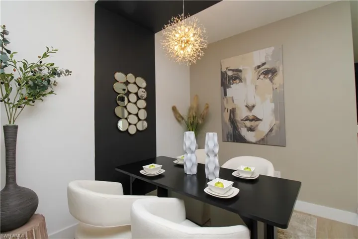 Dining area with a chandelier and baseboards