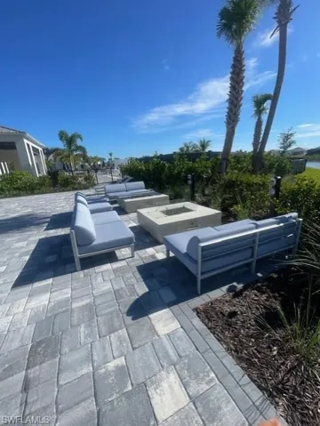 View of home's community with outdoor seating and a patio