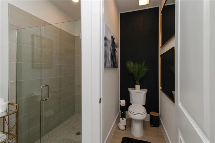 Bathroom featuring toilet and a shower stall