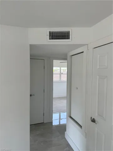 Corridor featuring tile flooring